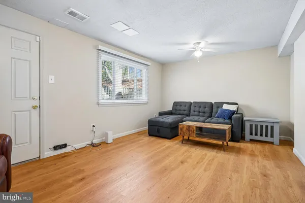 a bedroom with a bed couch and window