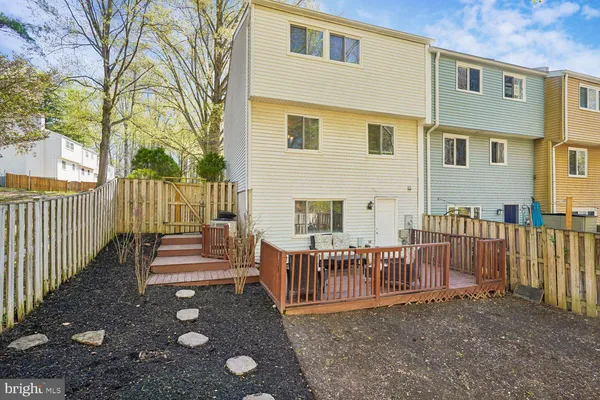 a view of a house with wooden fence