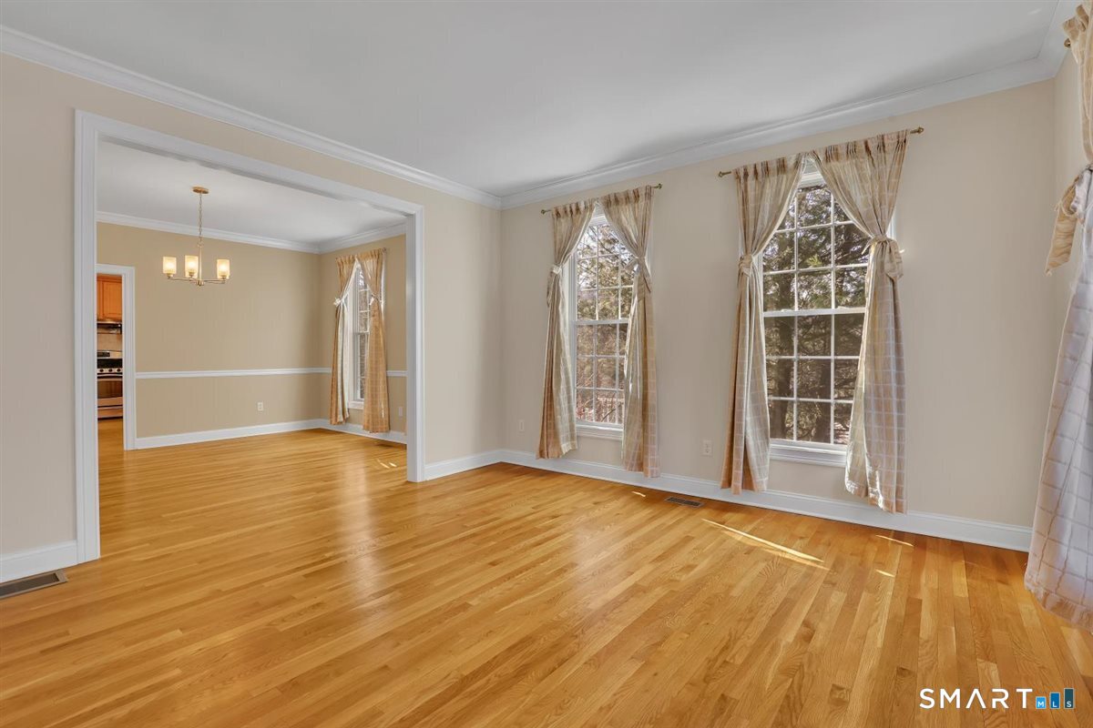 25 Fenwick Drive Avon, CT 06001 - Photo 17 of 40 a view of an empty room with wooden floor and a window