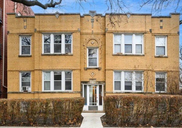 a front view of a building with a lot of windows
