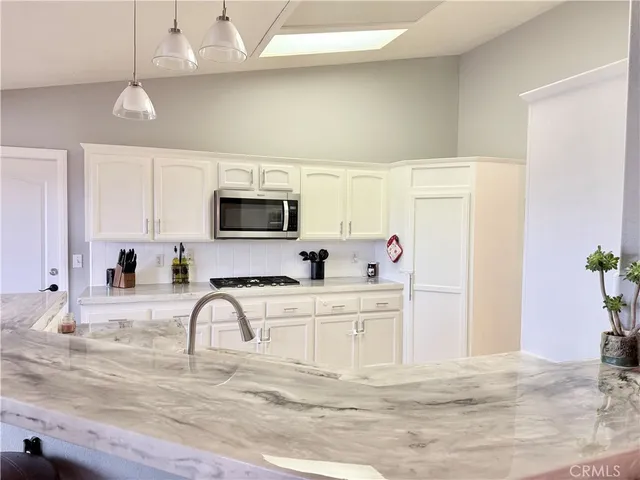 a view of a dining room with furniture and a window