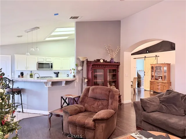 a living room with furniture and a large mirror