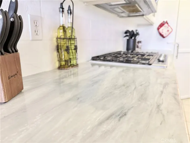 a kitchen with stainless steel appliances a sink a stove a refrigerator and cabinets