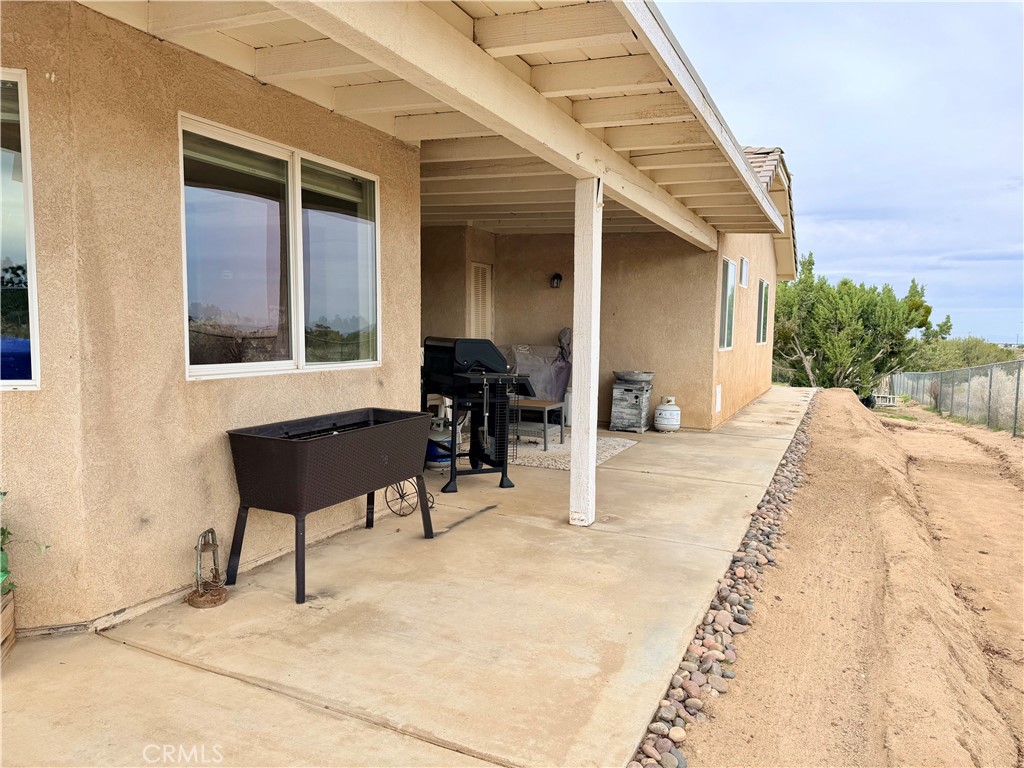 7915 Outpost Road Oak Hills, CA 92344 - Photo 25 of 54 a view of a house with backyard and sitting area