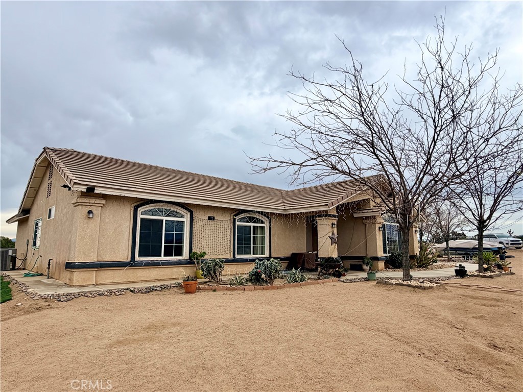 7915 Outpost Road Oak Hills, CA 92344 - Photo 30 of 54 a view of a yard with a car parked in front of it