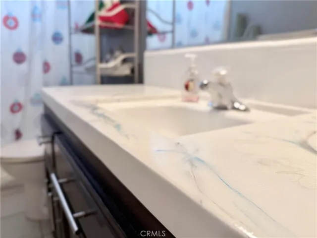 a spacious bathroom with a tub sink and mirror