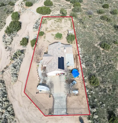 a dining room with wooden floor a chandelier a wooden table and chairs