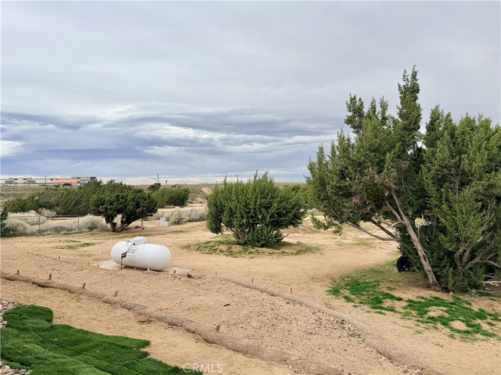 7915 Outpost Road Oak Hills, CA 92344 - Photo 48 of 54 a view of a dry yard with wooden fence
