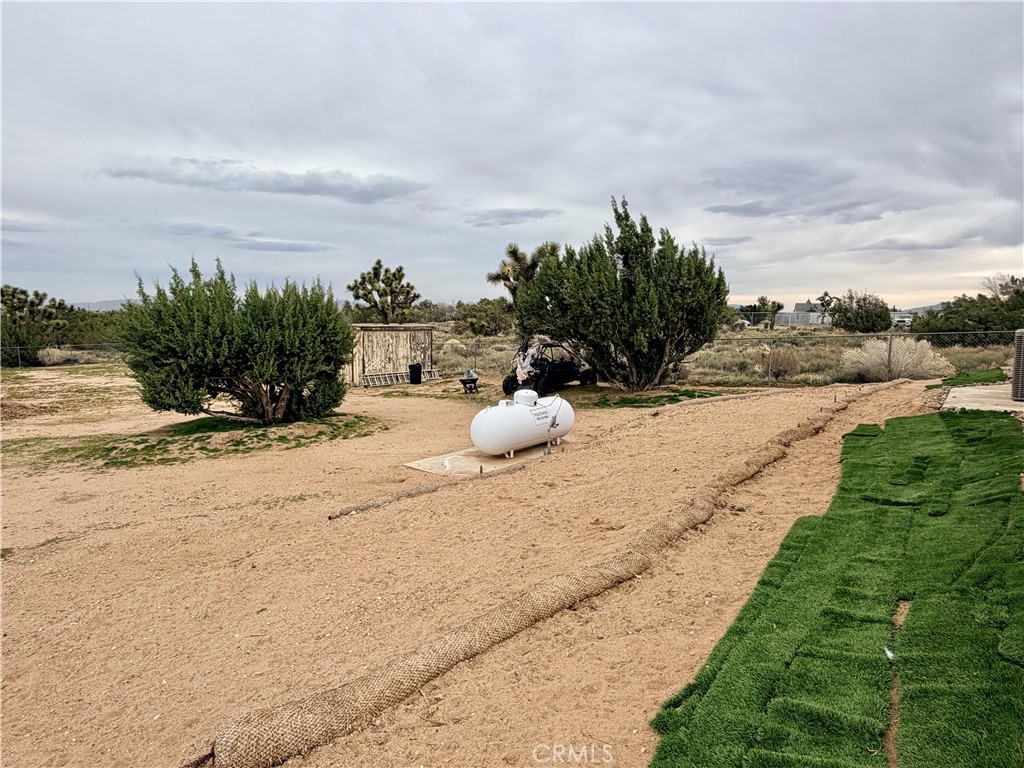 7915 Outpost Road Oak Hills, CA 92344 - Photo 49 of 54 a view of a dry yard with wooden fence