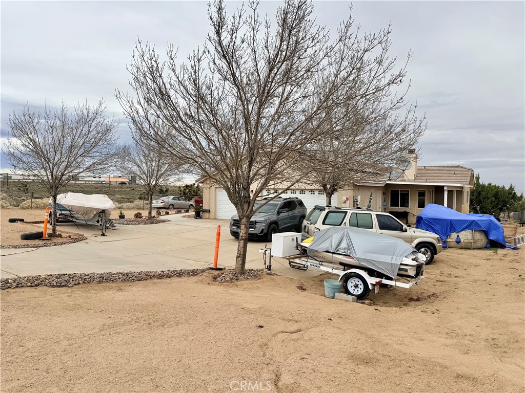 7915 Outpost Road Oak Hills, CA 92344 - Photo 51 of 54 a car parked in front of a house