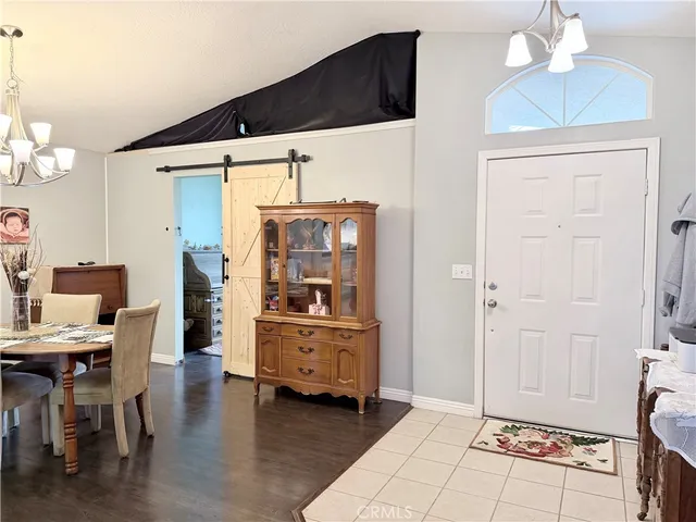 a kitchen with granite countertop a sink stainless steel appliances and white cabinets