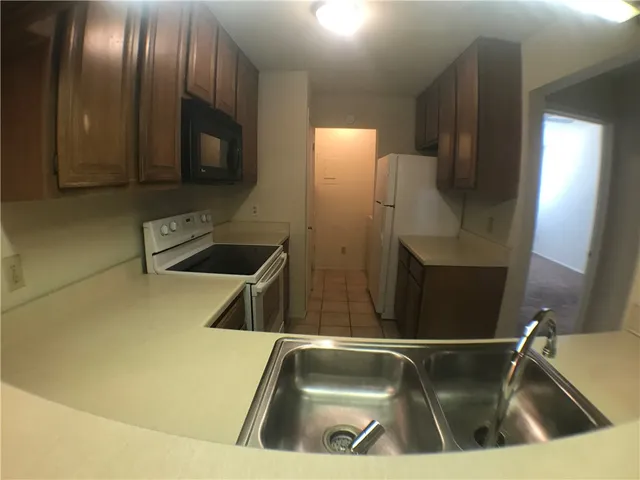 a kitchen with a sink and a refrigerator