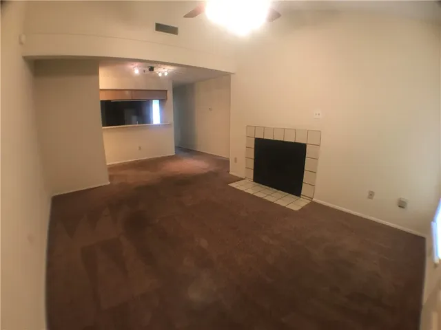a view of empty room with a fireplace