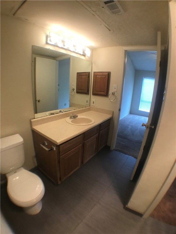 806 West 24th Street, Unit 304 Austin, TX 78705 - Photo 9 of 17 a bathroom with a toilet sink and mirror