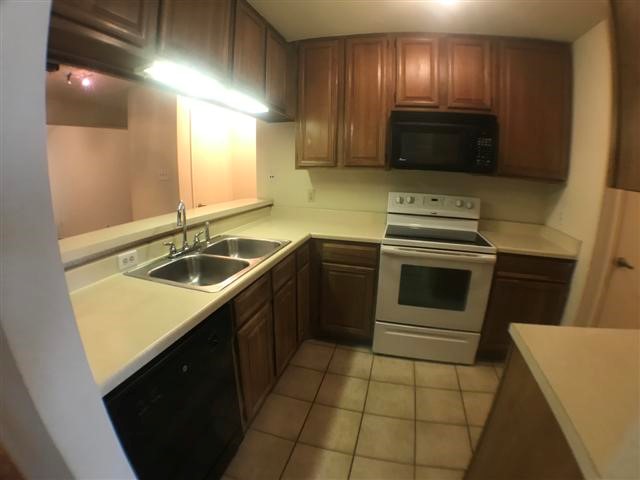 806 West 24th Street, Unit 304 Austin, TX 78705 - Photo 10 of 17 a kitchen with a sink a stove and cabinets