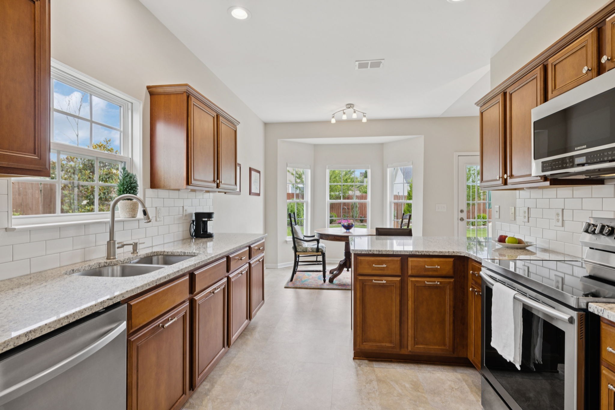 4060 Sequoia Trail Spring Hill, TN 37174 - Photo 12 of 41 a kitchen with stainless steel appliances granite countertop a sink stove microwave and cabinets