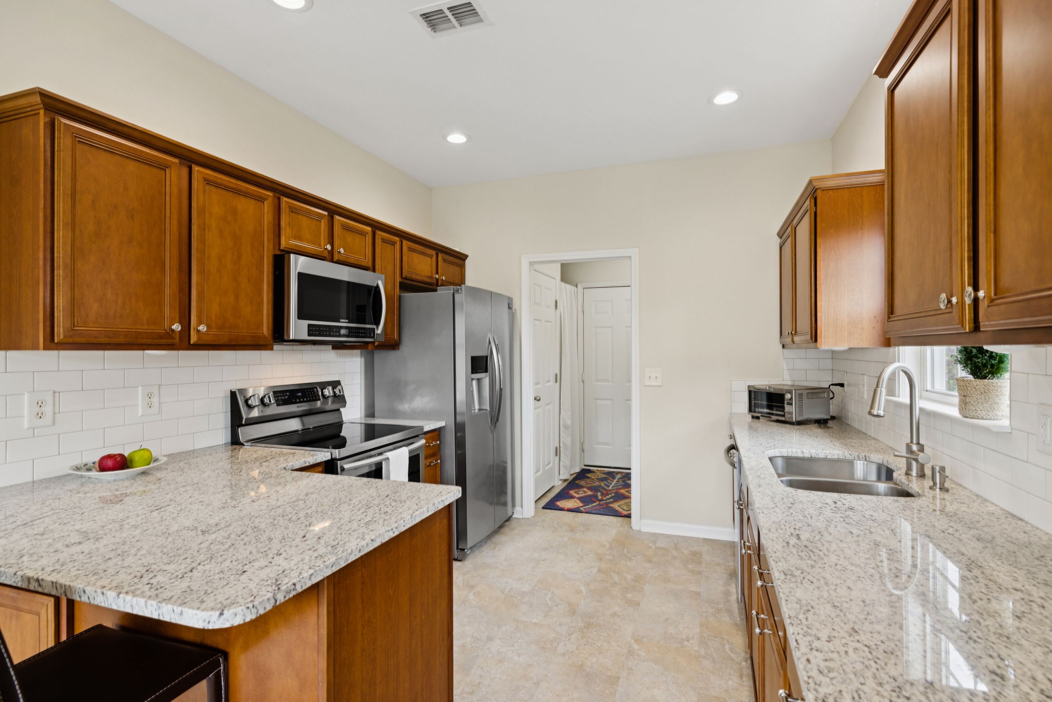 4060 Sequoia Trail Spring Hill, TN 37174 - Photo 13 of 41 a kitchen with stainless steel appliances granite countertop a sink stove microwave refrigerator and wooden cabinets