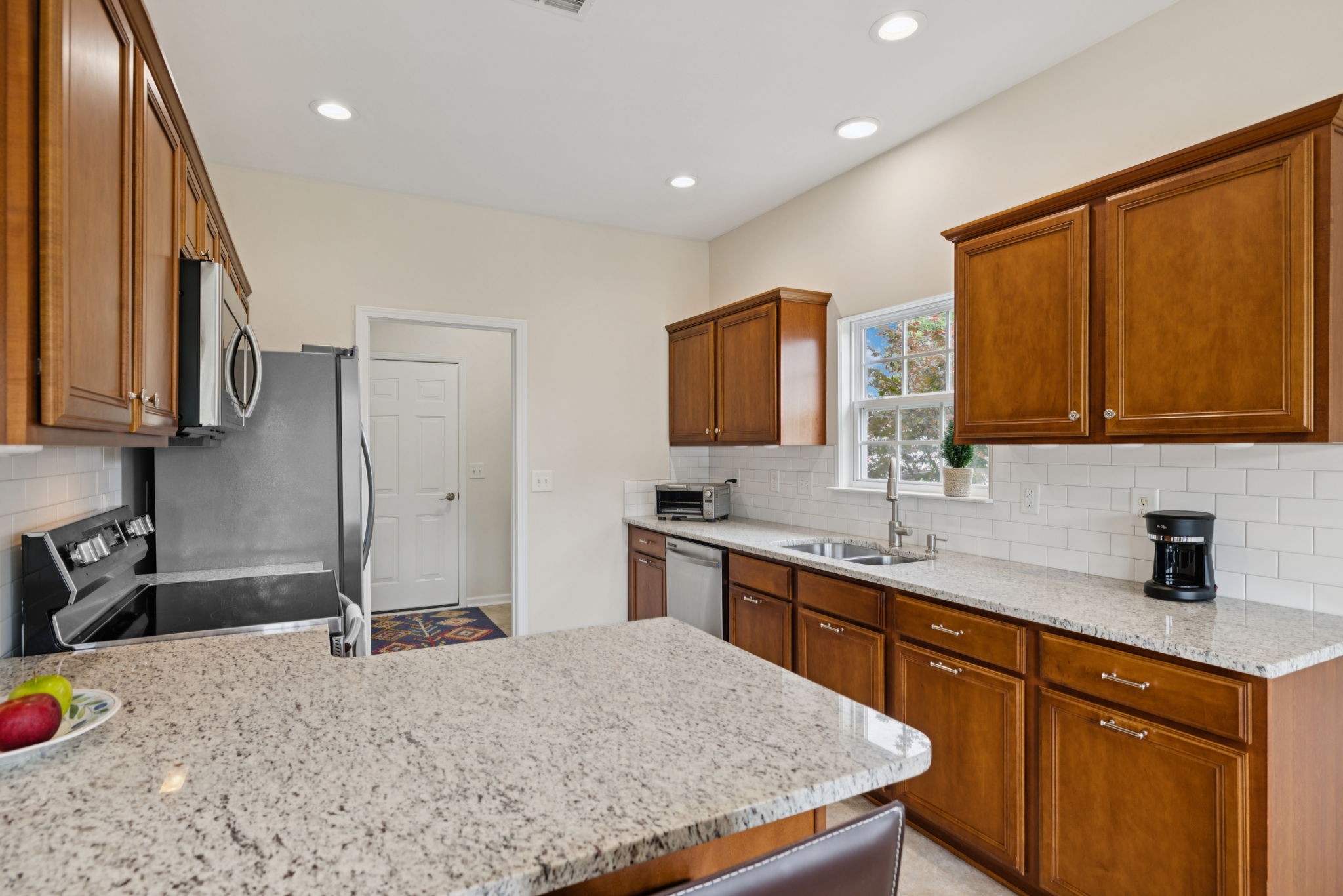 4060 Sequoia Trail Spring Hill, TN 37174 - Photo 10 of 41 a kitchen with stainless steel appliances granite countertop a sink stove and refrigerator