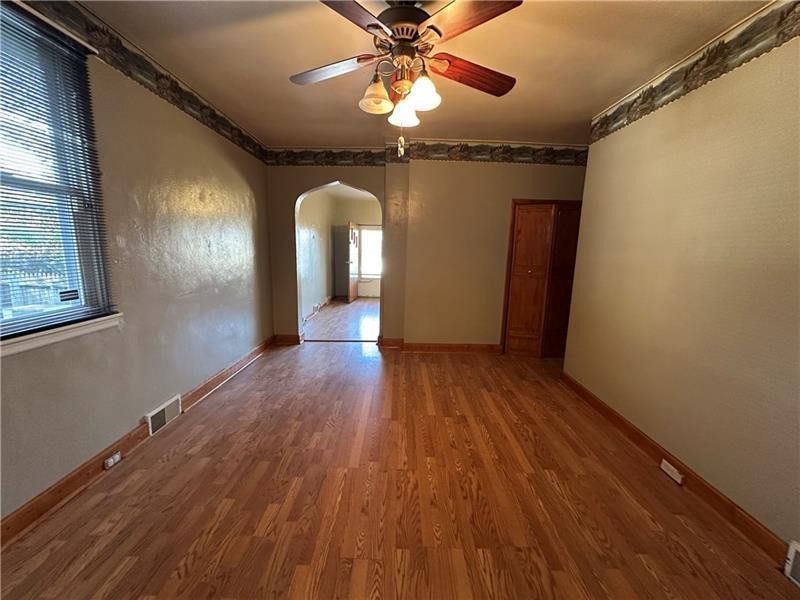 1447 Fleming Avenue McKees Rocks, PA 15136 - Photo 13 of 37 a view of a livingroom with wooden floor and a ceiling fan