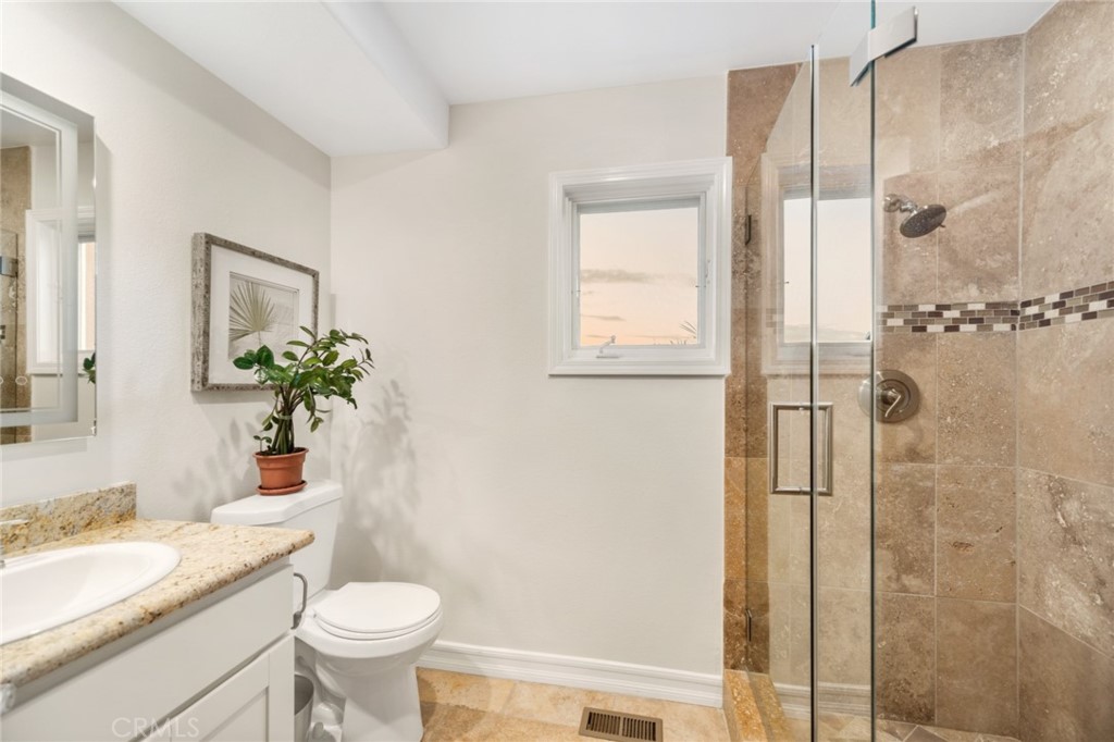 81 Marbella San Clemente, CA 92673 - Photo 19 of 65 a bathroom with a granite countertop sink toilet and shower