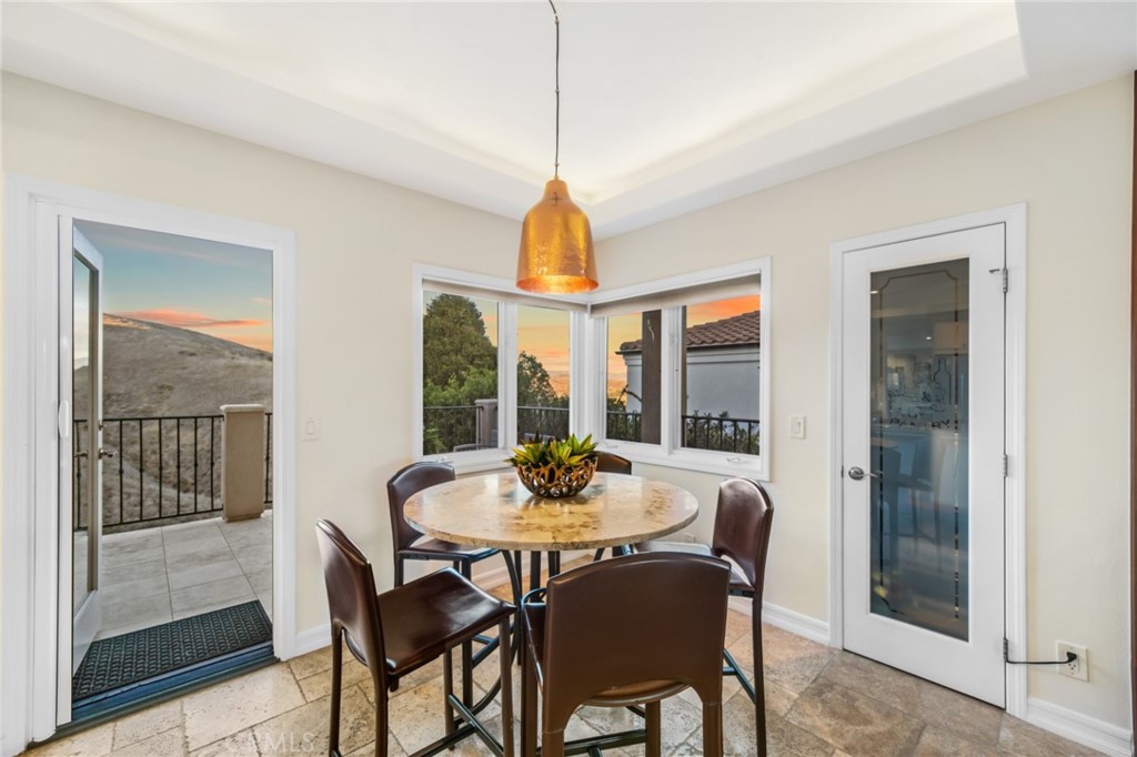 81 Marbella San Clemente, CA 92673 - Photo 25 of 65 a dining room with furniture a chandelier and wooden floor