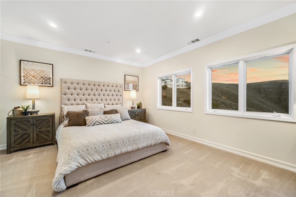 81 Marbella San Clemente, CA 92673 - Photo 44 of 65 a bedroom with a large bed and a large window