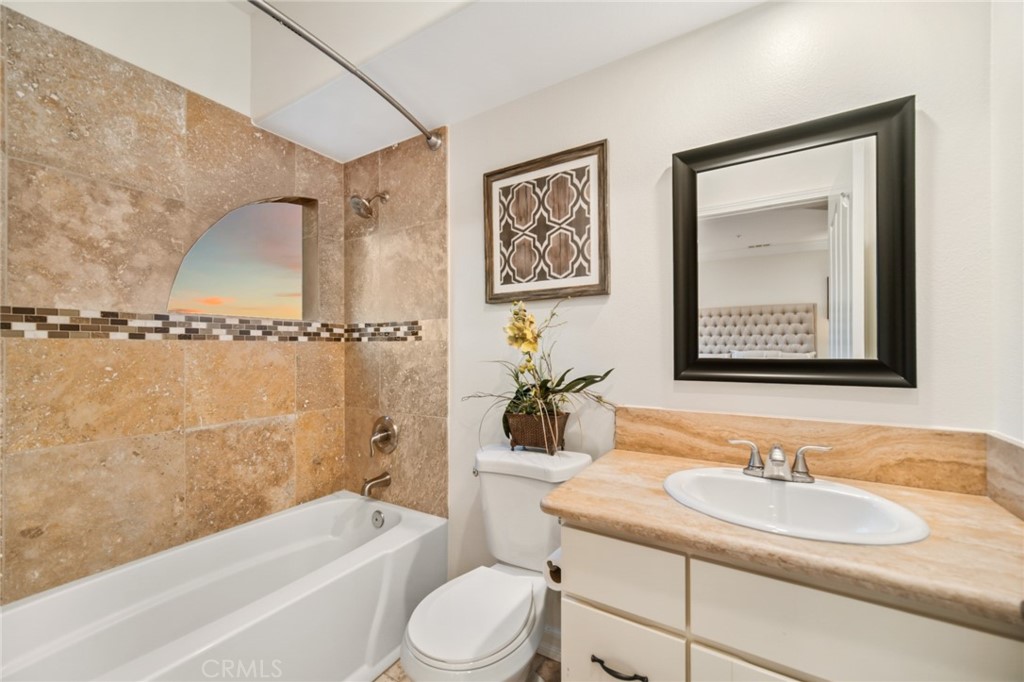81 Marbella San Clemente, CA 92673 - Photo 47 of 65 a bathroom with a granite countertop sink mirror toilet and bathtub