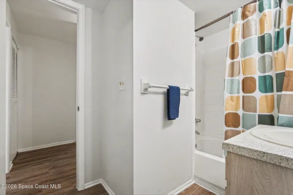 a bathroom with a granite countertop shower and a sink