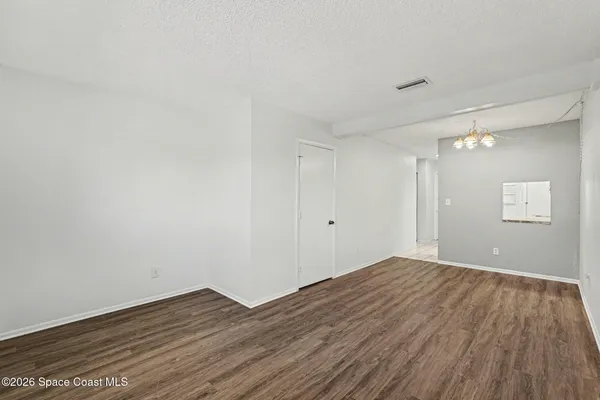 a view of room with wooden floor