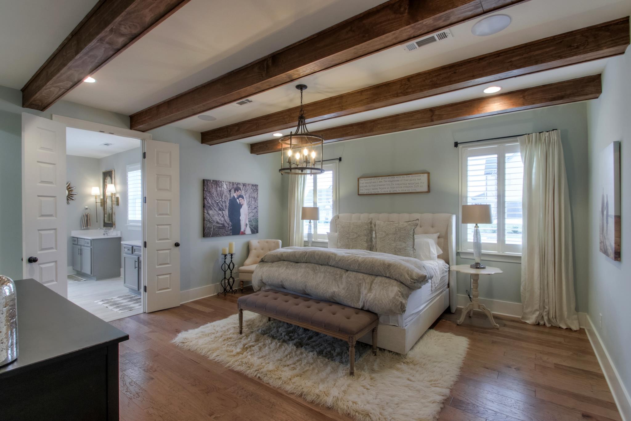 113 Vanner Road Mount Juliet, TN 37122 - Photo 16 of 30 a spacious bedroom with a large bed and a chandelier