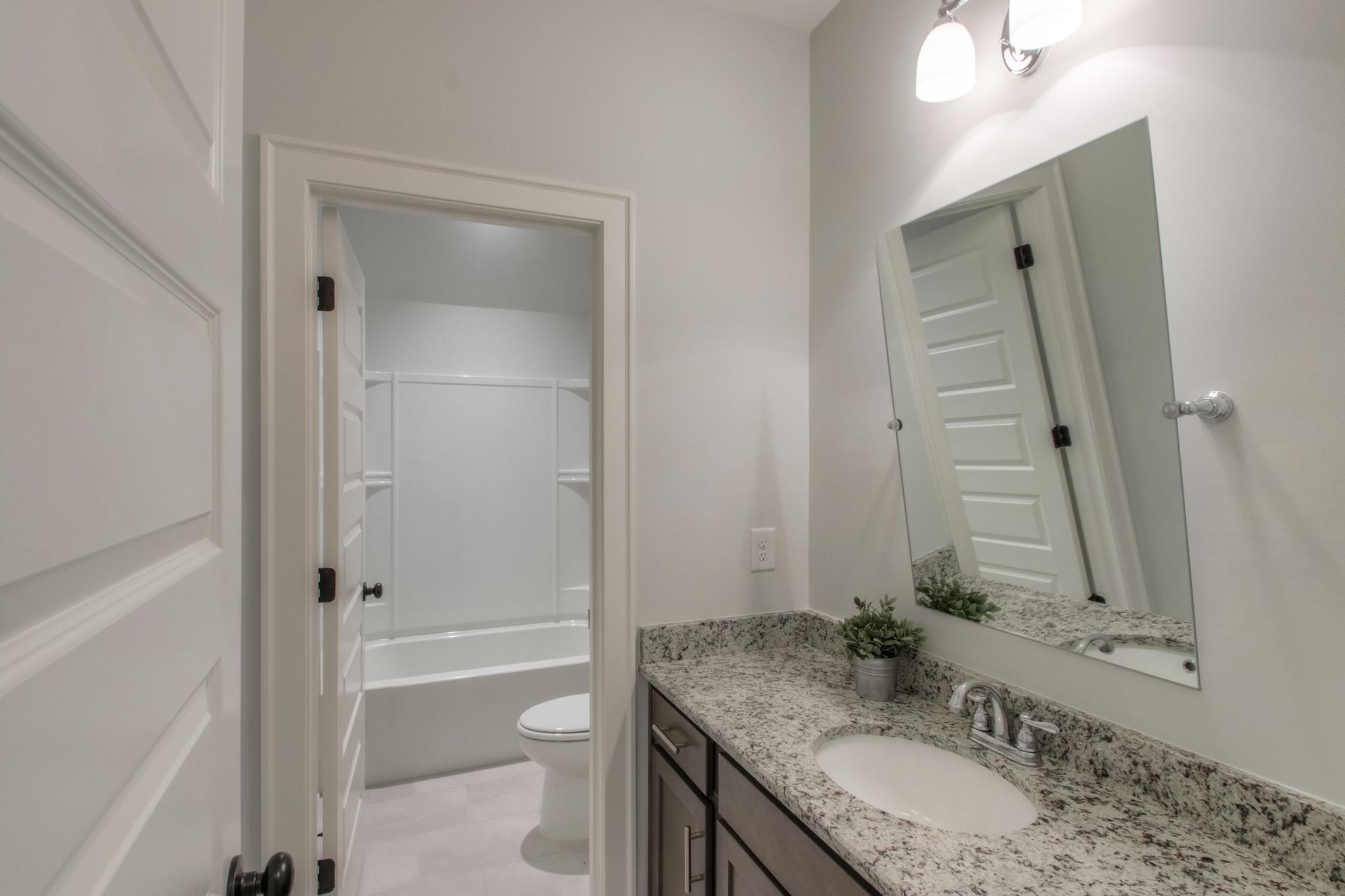 113 Vanner Road Mount Juliet, TN 37122 - Photo 22 of 30 a bathroom with a granite countertop sink toilet and shower