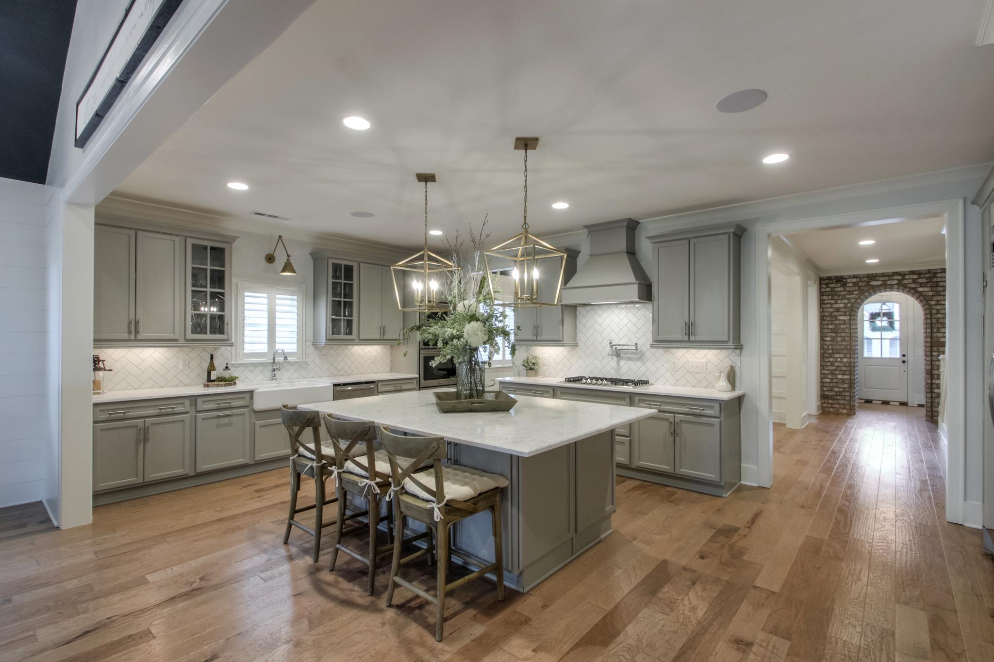 113 Vanner Road Mount Juliet, TN 37122 - Photo 10 of 30 a kitchen with center island wooden floor stainless steel appliances and dining table