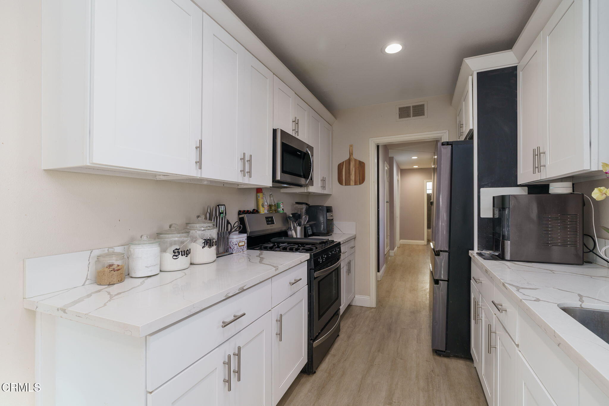 3651 South E Street Oxnard, CA 93033 - Photo 12 of 31 a kitchen with a sink a stove and refrigerator