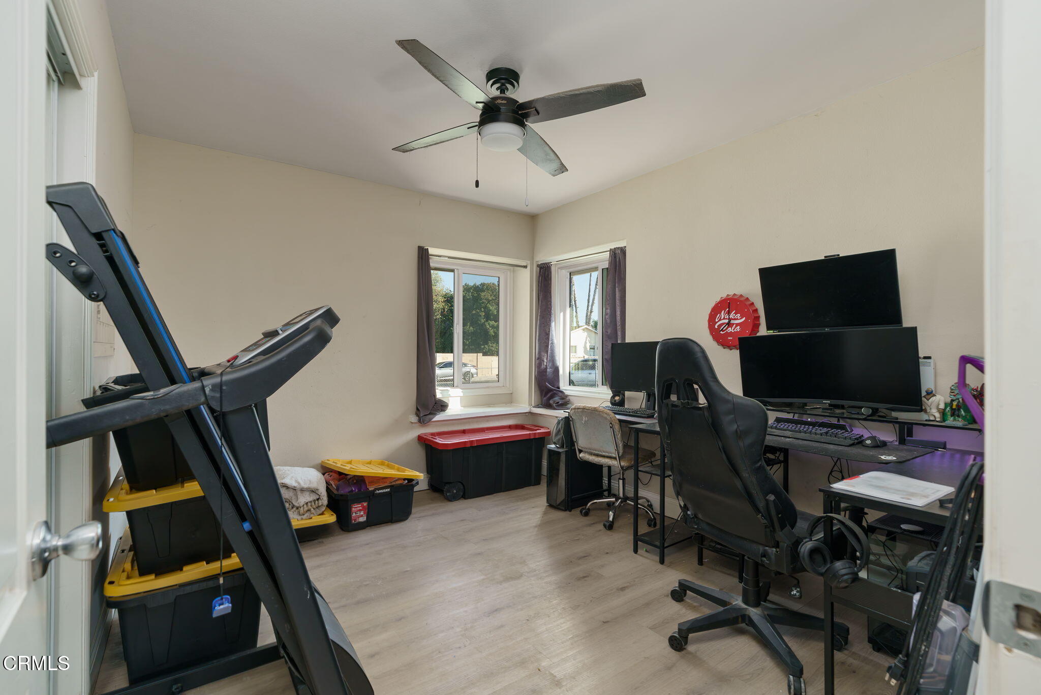 3651 South E Street Oxnard, CA 93033 - Photo 14 of 31 a view of a workspace with furniture and a ceiling fan