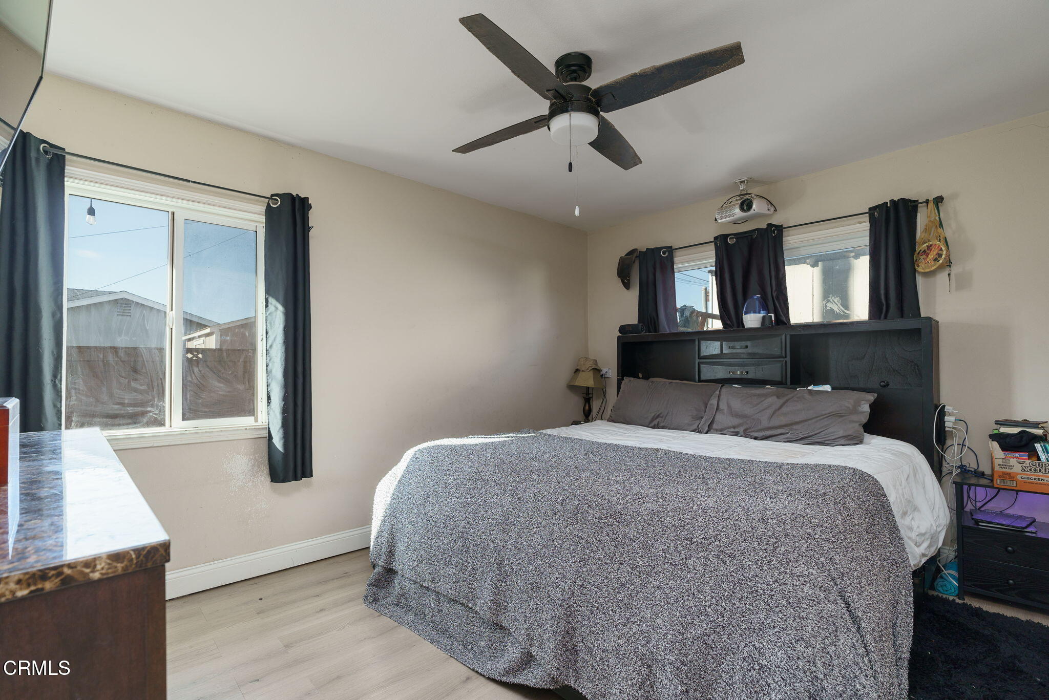 3651 South E Street Oxnard, CA 93033 - Photo 15 of 31 a bedroom with a large bed and a large window