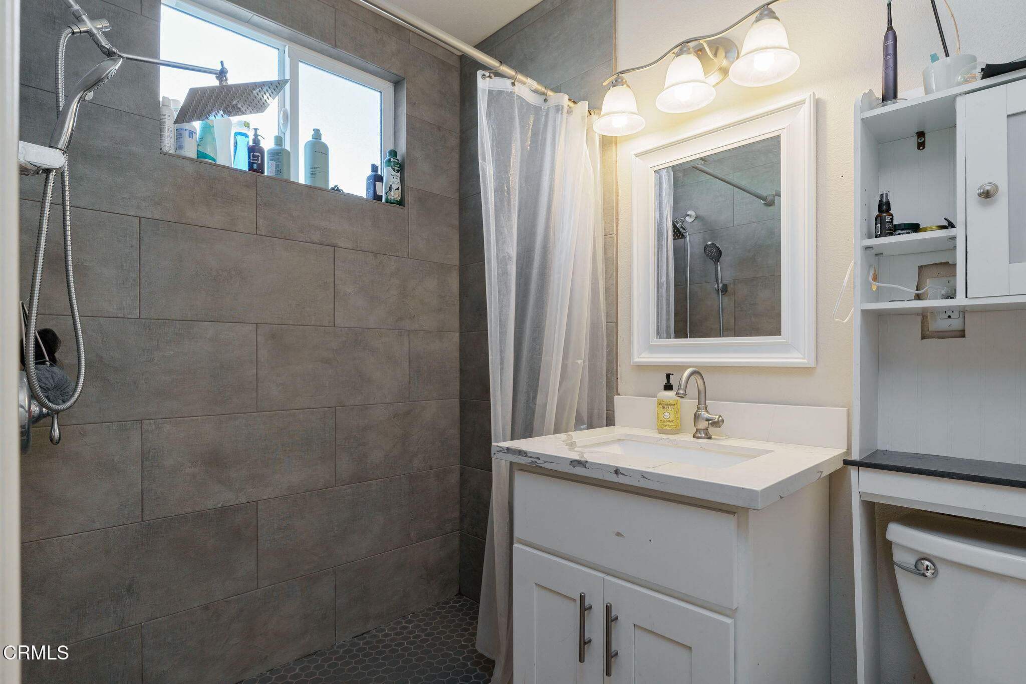 3651 South E Street Oxnard, CA 93033 - Photo 17 of 31 a bathroom with a sink and mirror