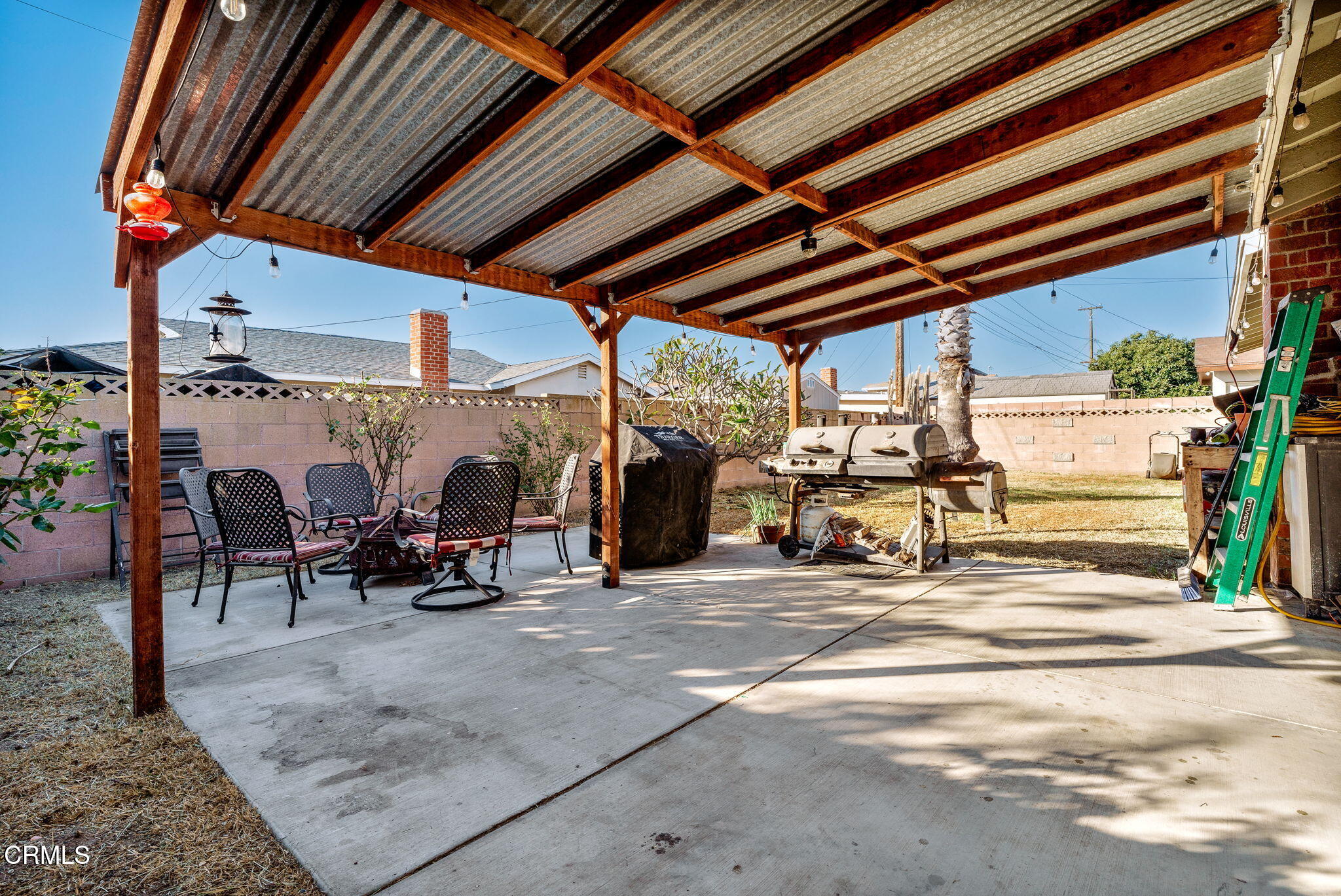 3651 South E Street Oxnard, CA 93033 - Photo 20 of 31 a view of a patio with table and chairs under an umbrella