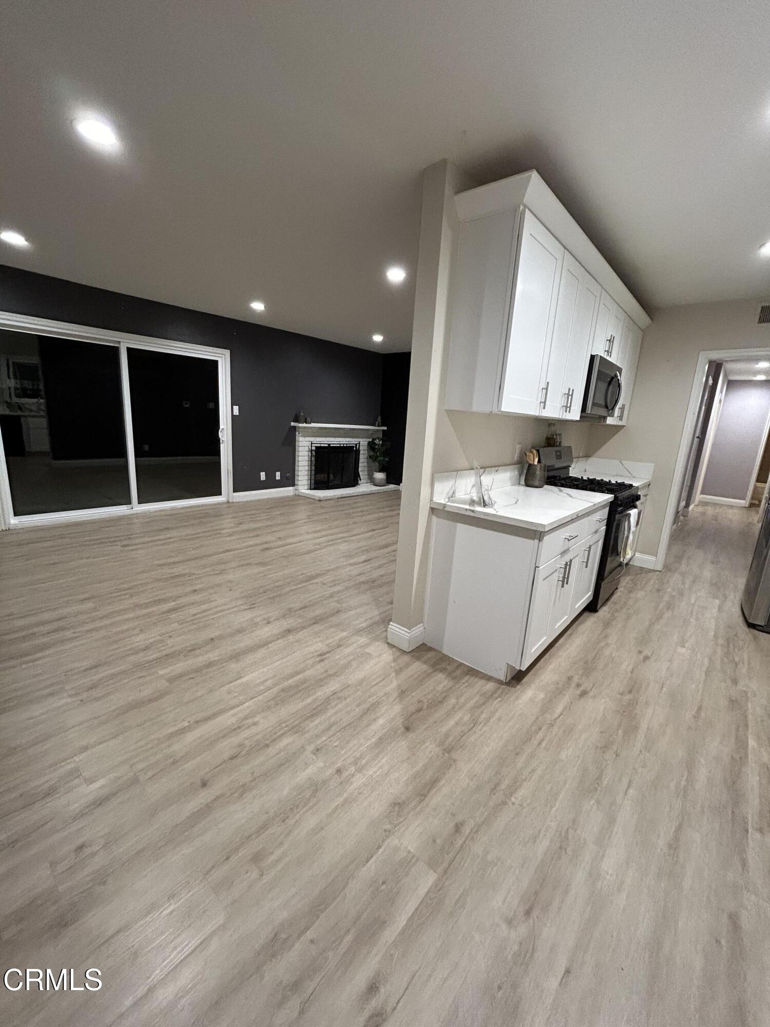 3651 South E Street Oxnard, CA 93033 - Photo 24 of 31 a living room with stainless steel appliances wooden floors and view kitchen