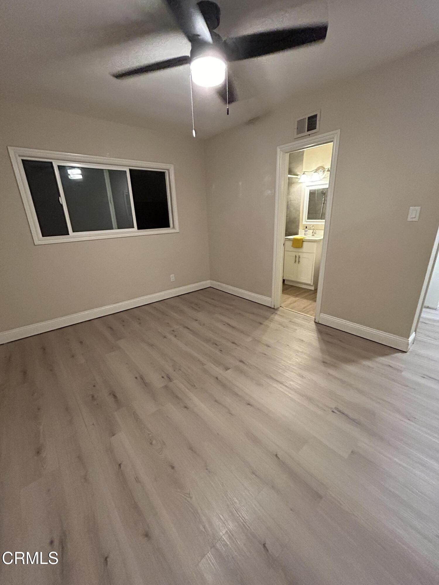 3651 South E Street Oxnard, CA 93033 - Photo 26 of 31 a view of an empty room with wooden floor