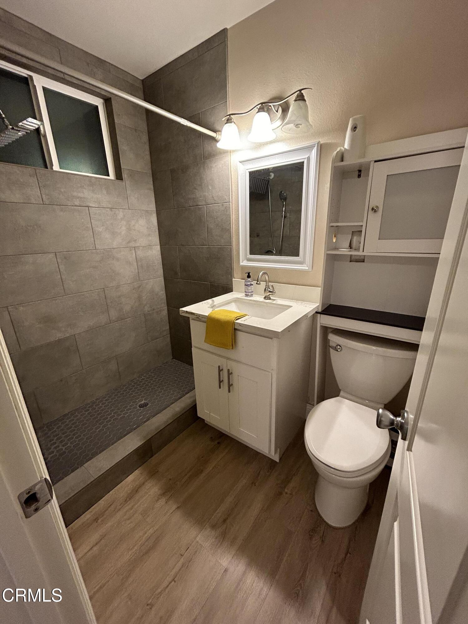 3651 South E Street Oxnard, CA 93033 - Photo 27 of 31 a bathroom with a toilet sink and mirror