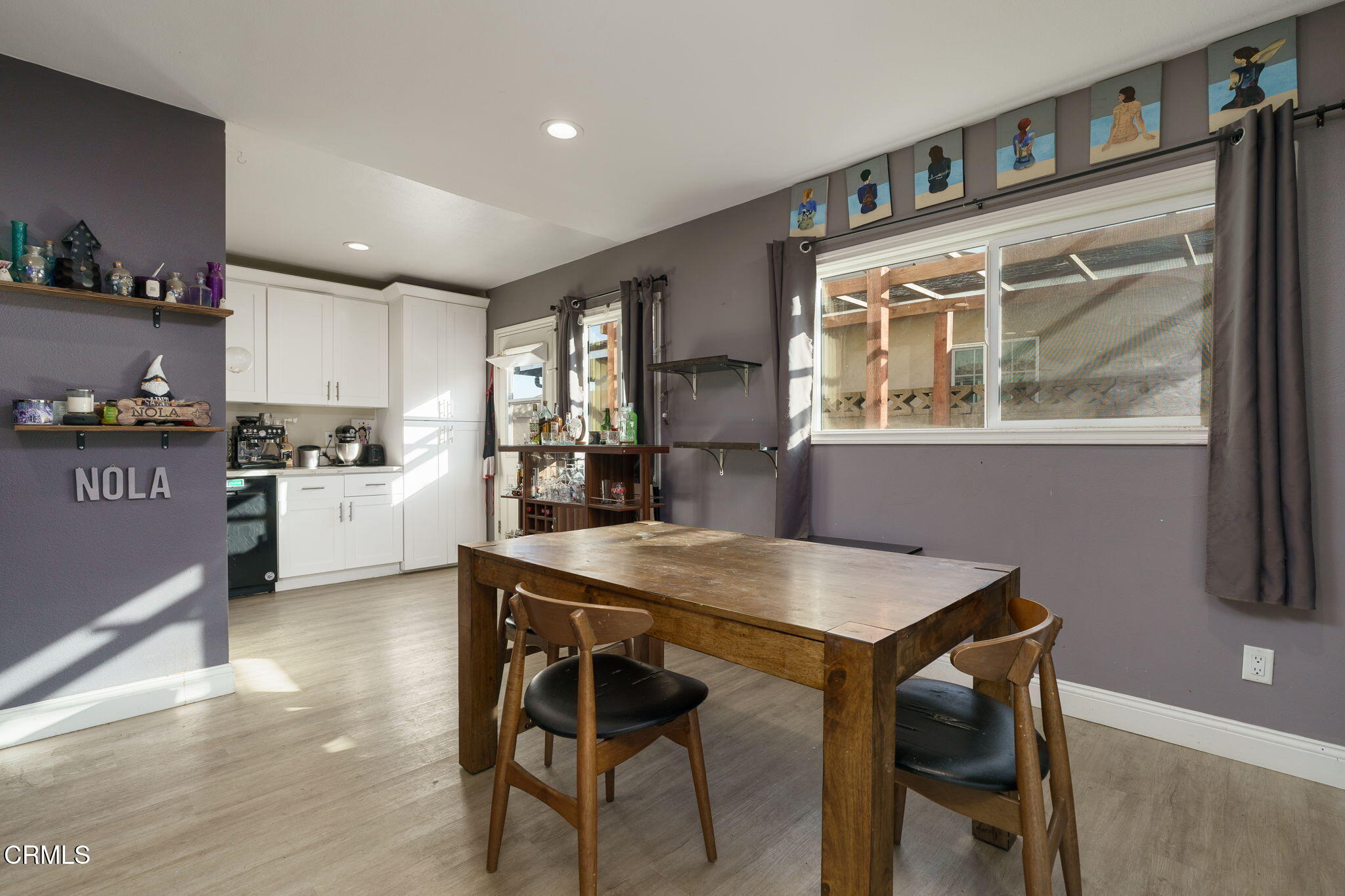 3651 South E Street Oxnard, CA 93033 - Photo 7 of 31 a kitchen with a table chairs refrigerator and cabinets