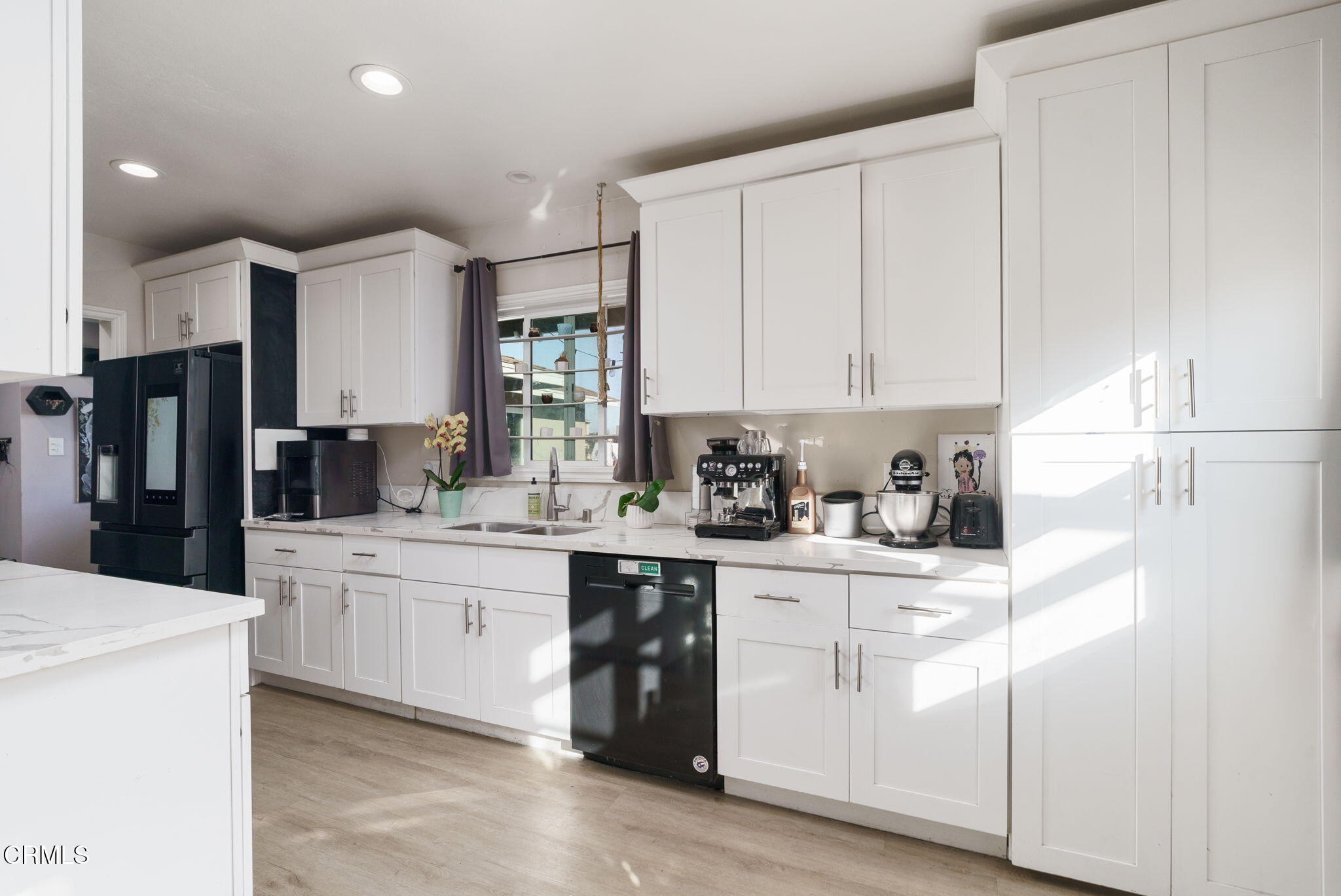 3651 South E Street Oxnard, CA 93033 - Photo 10 of 31 a kitchen with white cabinets and white appliances