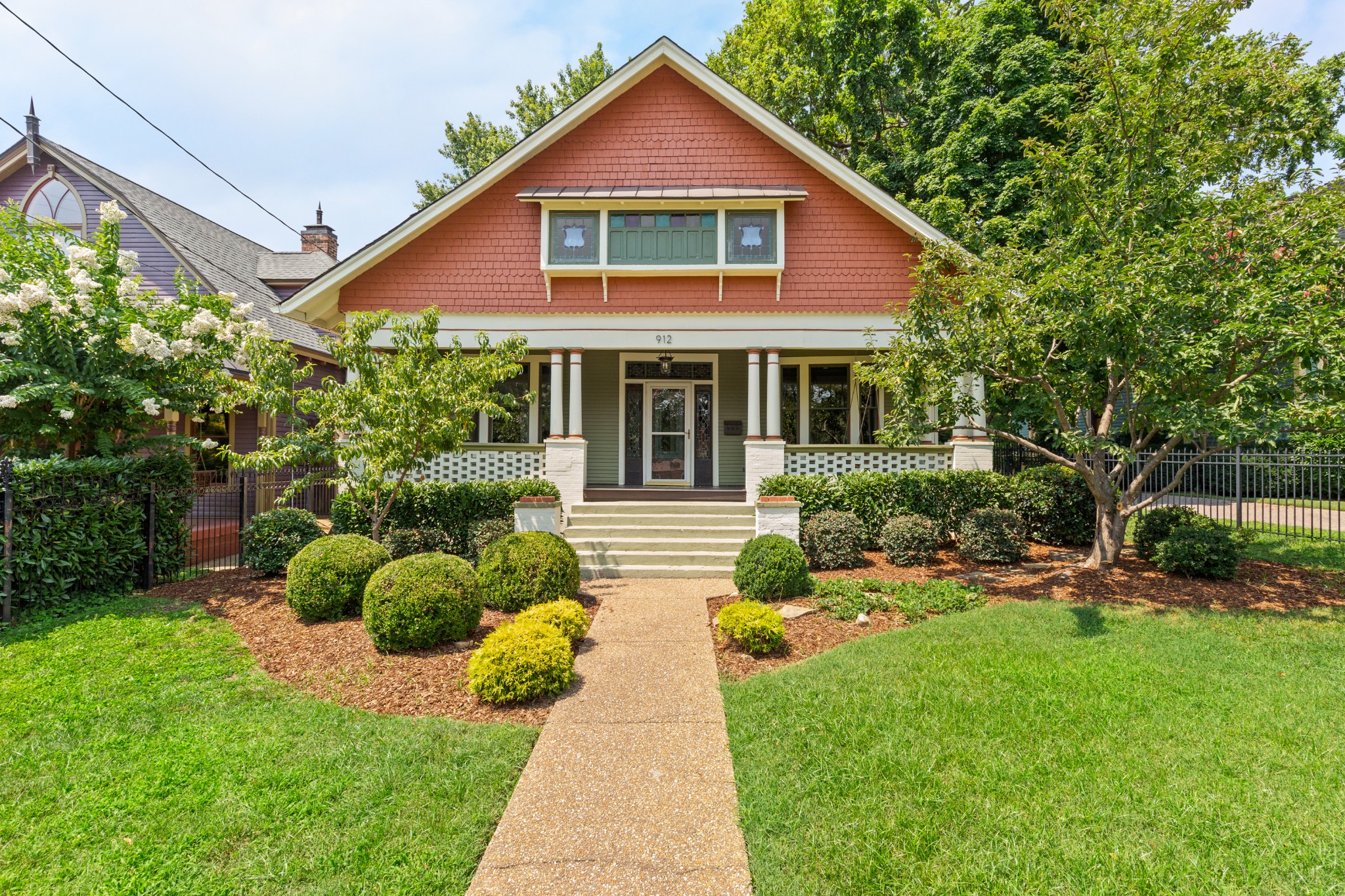 a front view of house with yard and green space