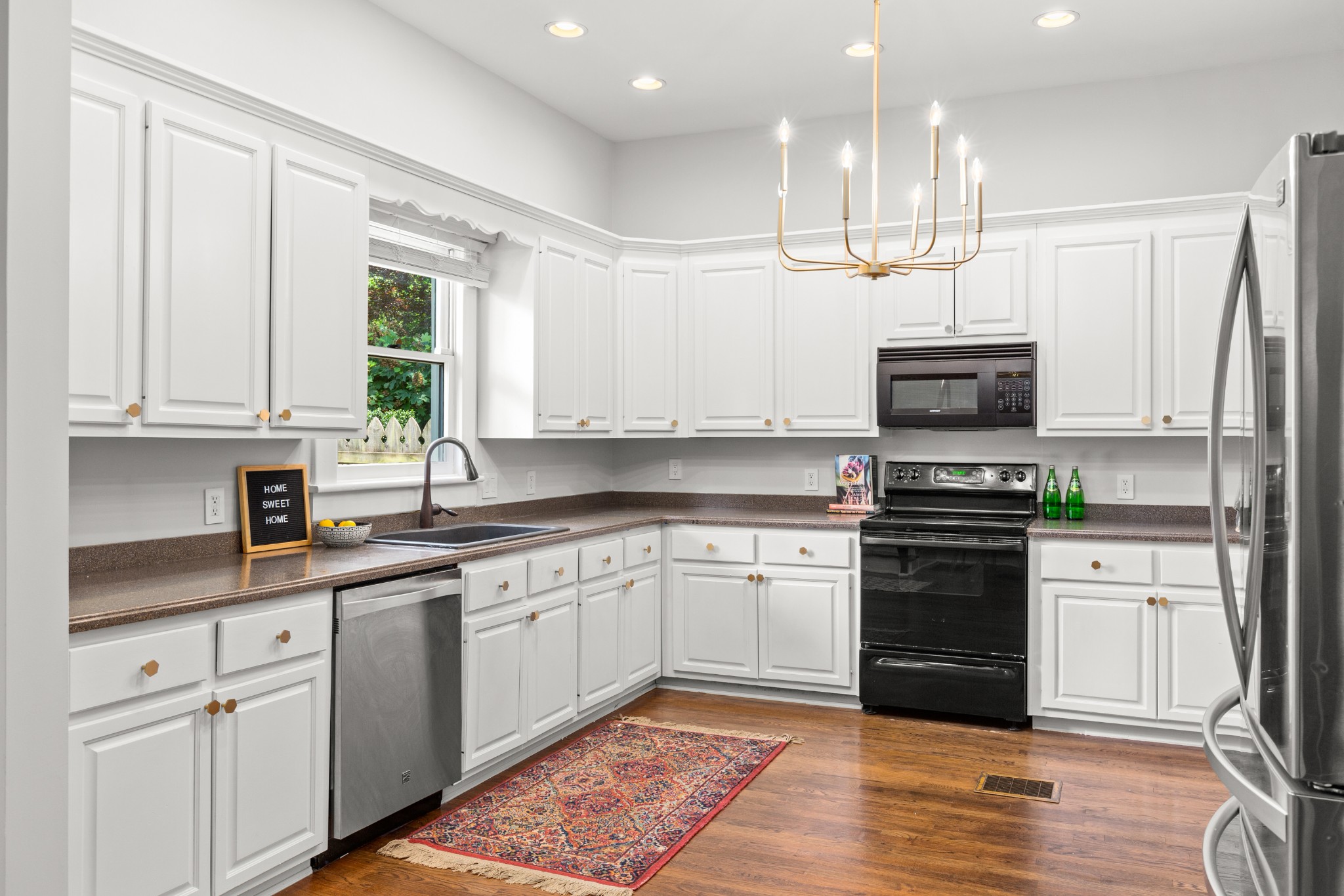 912 South Douglas Avenue Nashville, TN 37204 - Photo 13 of 34 a kitchen with stainless steel appliances granite countertop a stove top oven a sink dishwasher and a microwave oven with wooden cabinets