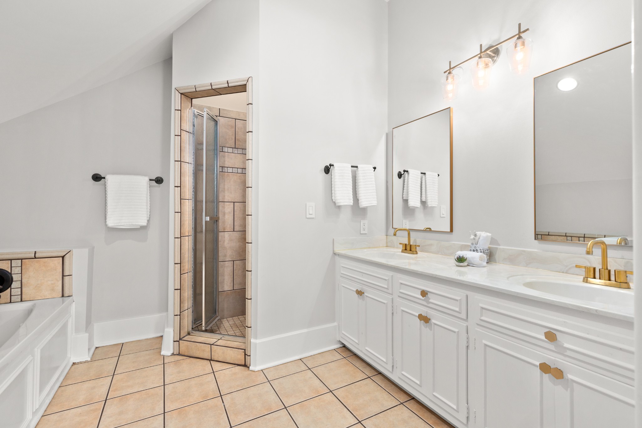 912 South Douglas Avenue Nashville, TN 37204 - Photo 24 of 34 a spacious bathroom with a double vanity sink a mirror and a shower