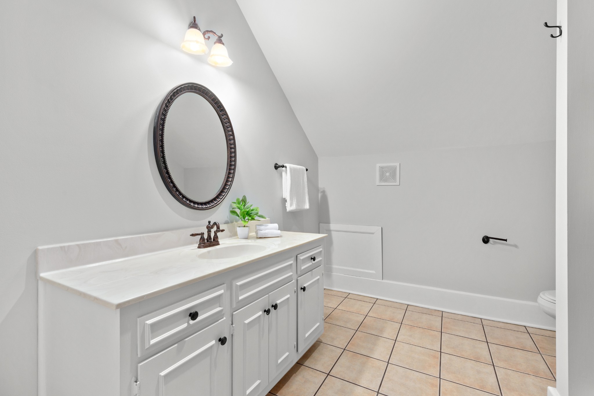 912 South Douglas Avenue Nashville, TN 37204 - Photo 30 of 34 a bathroom with a sink a vanity and a mirror