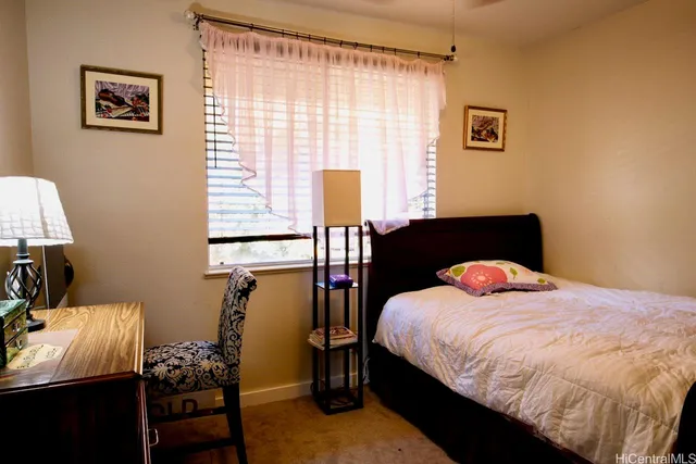 a bedroom with a bed and a table