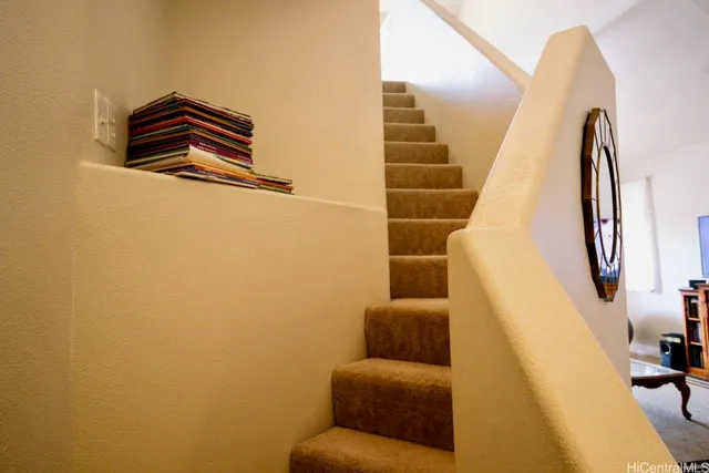 a view of hallway with furniture and a window