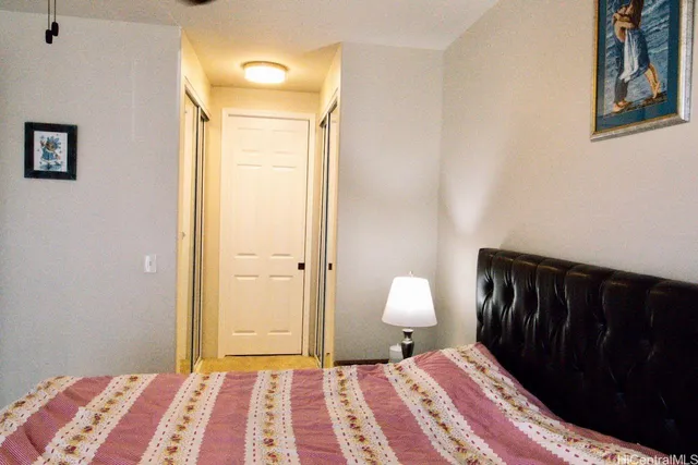 a bedroom with a bed and a lamp