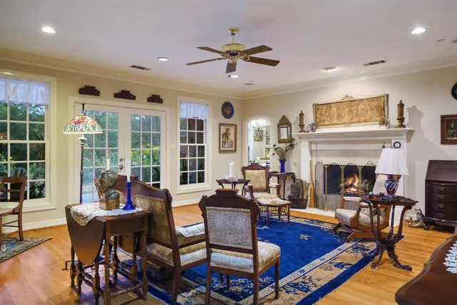 a living room with furniture fireplace and window